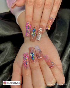 Long Coffin Nails With Pink Glitter, Nude Polish, Silver Chrome French Tip, Blue Rhinestones And 21 Written In Silver