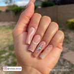 Long Coffin Nude Coffin Nails With Ombre Effect, White Designs And Rhinestones