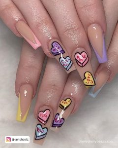 Long Coffin Valentines Acrylic Nails With Nude Base And Pastel Blue, Yellow, Purple And Pink Tips With Colorful Love Heart Nail Art