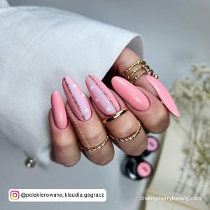 Long Light Pink Almond Nails With Two Nails With Lighter Pink Section And Heart Design