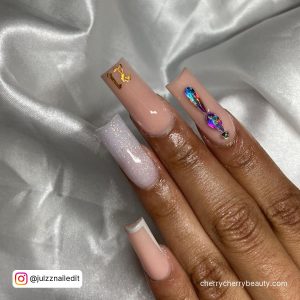 Long Square Tip White And Nude Nails With Thin White French Tip, Blue Rhinestones And 21 Written In Gold Glitter On The Tip