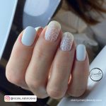 Matt White Nails With Design On Two Fingers