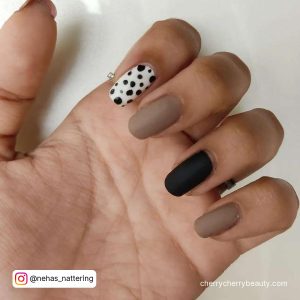 Matte Black And White Nails With Polka Dots On Index Finger