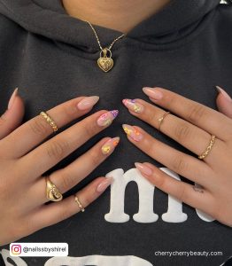 Nude Almond Nails With Pastel Colored Love Heart Designs
