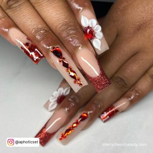 Nude And Dark Red Long Square Tip Nails With Red Glitter Tips, Red Rhinestones, White Flower Design And 21 Written In White On A Tortoise Shell Pattern Tip