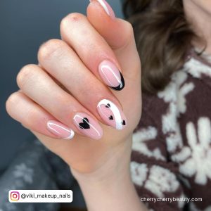 Nude Round Tip Nails With White And Black French Tip And Black Hearts