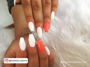 Orange And White Acrylic Nails On White Furry Surface