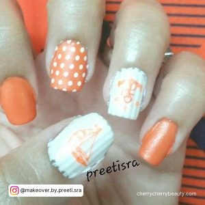 Orange And White Nail Ideas With Unique Patterns On Two Fingers