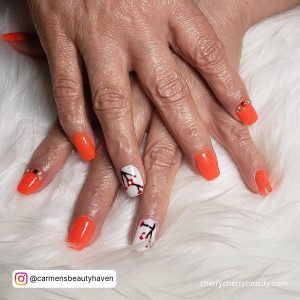 Orange And White Nails Designs On A White Surface