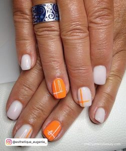 Orange Nails With White Design On Fingers