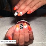 Orange White And Black Nails With Check Pattern On One Finger