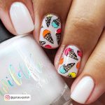 Pearly Icecream-Themed Summer White Nail Design Holding Gel Polish Container