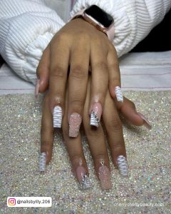 Pink And White Rhinestone Nails On A Glittery Surface
