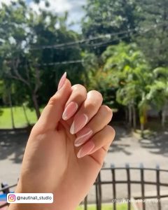 Pink White Swirl Nails In Front Of Trees