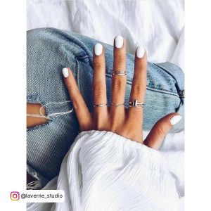 Plain Short White Summer Nails On A Girl'S Legs With Jean Trouser