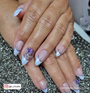 Purple And White French Nails On A Black Surface