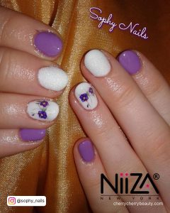 Purple And White Short Nails On A Leather Surface