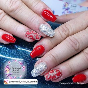 Red And Silver Acrylic Nails With Design On Two Fingers