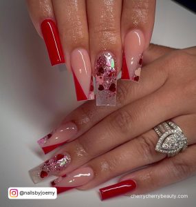 Red, Clear And Nude Acrylic Square Tip Long Nails With Red Diagonal Tip Design And Glitter Design
