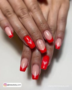 Red French Tip Valentine Nails With One Red Nail With A Pink Heart
