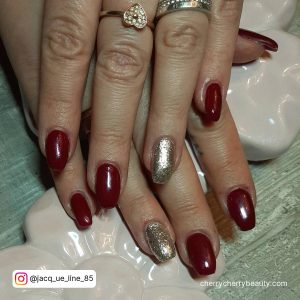 Red Nails Silver Glitter On Ring Finger