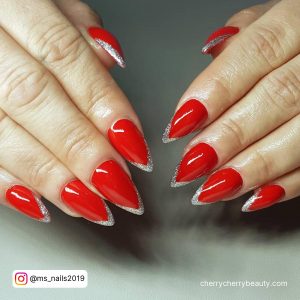 Red Nails Silver Tips In Stilleto Shape