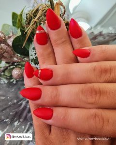 Red Nails With Silver Glitter Line On Ring Finger