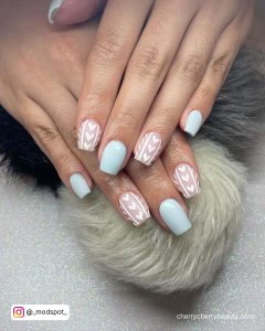 Short Coffin Nails With Light Blue And Nude Nails With White Heart Design