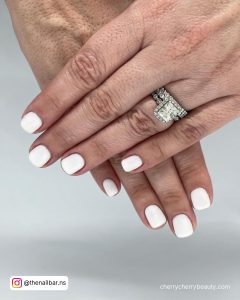Short Matte White Acrylic Nails Paired With A Diamond Ring