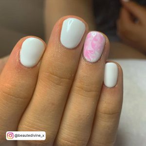 Short Pink And White Summer Nails On A White Surface