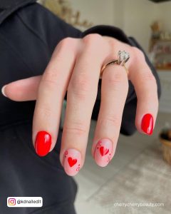 Short Round Tip Red And Pink Nails With Red Hearts On The Pink Nails