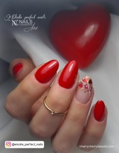 Short Round Tip Red Nails With One Nude Nails With Simple Red And White Design
