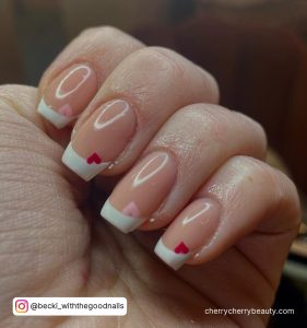 Short Square Tip French Tip Nails With A Small Pink Or Red Heart On Each Tip