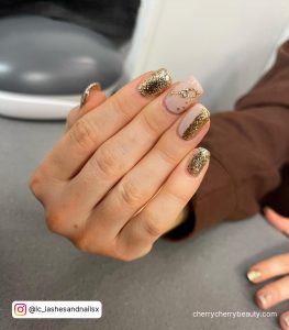Short Square Tip Nude And Gold Glitter Nails With Gold Glitter Champagne Glass Design