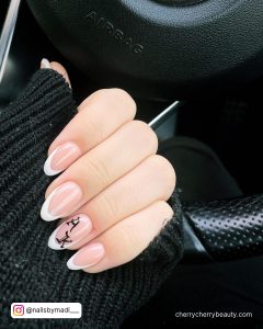 Short White Acrylic Nails With Black Design On Ring Finger