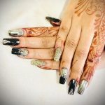 Silver And Black Nails With Henna On Hand