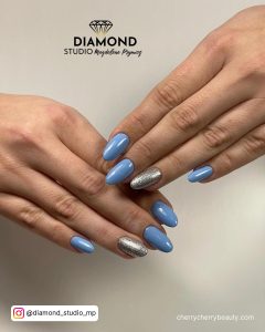 Silver And Light Blue Nails In Almond Shape