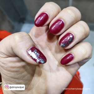 Silver And Red Nails With Glitter On Two Fingers