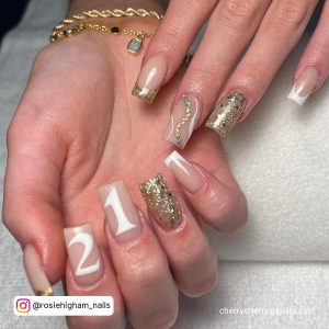Square Tip Gold Glitter, Gold Chrome Tip And White French Tip With 21 Written In White On Two Nails