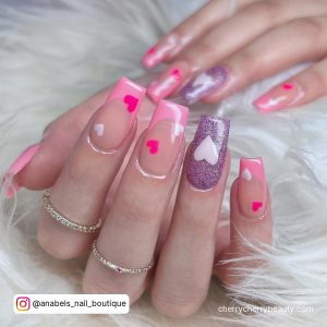 Square Tip Nude Nails With Pink French Tip And Pink Hearts With Purple Glitter Nails With White Heart