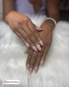 Tan Nails With White Lines On A Furry Surface