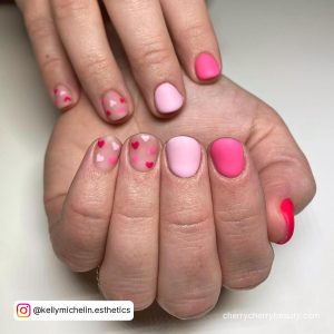 Valentines Day Short Nails In Light Pink, Pink And Red With Two Nude Nails With Pink And Red Hearts