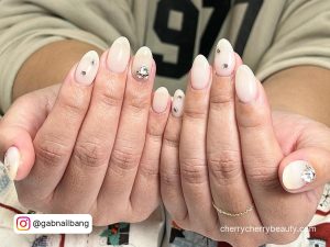 White Almond Shaped Nails With Rhinestones On Two Fingers
