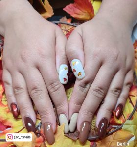 White And Brown Acrylic Nails On A Floral Print