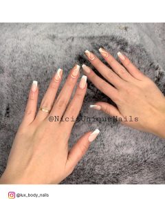 White And Orange Nails On A Grey Surface
