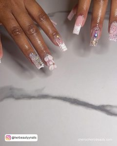 White And Silver Nails With Rhinestones On A Marble Surface