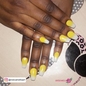 White And Yellow Ombre Nails On A Table