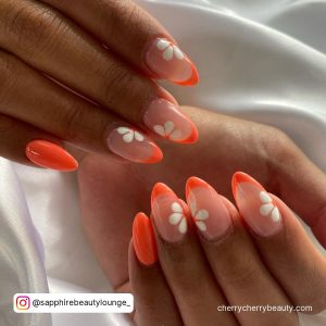 White Flower Design On Nails With Orange Tips