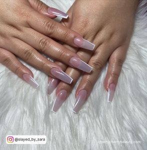 White French Outline Nails On A White Surface