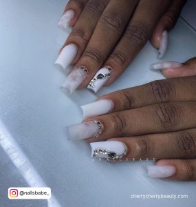 White Matte Coffin Nails With Rhinestones And Designs